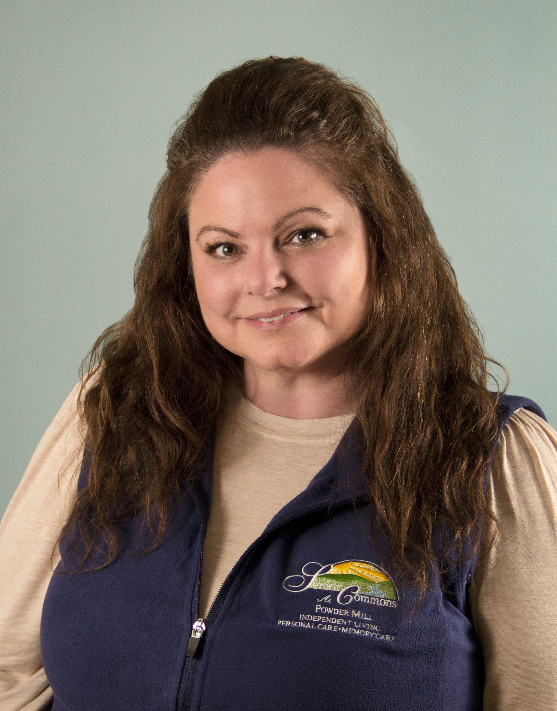 Professional headshot of woman wearing company vest