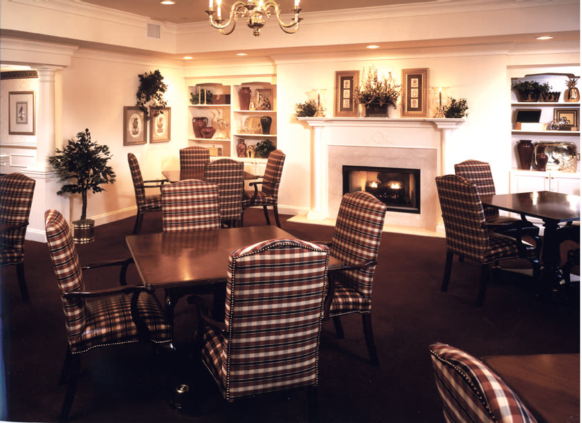 Cozy dining room with fireplace and plaid chairs