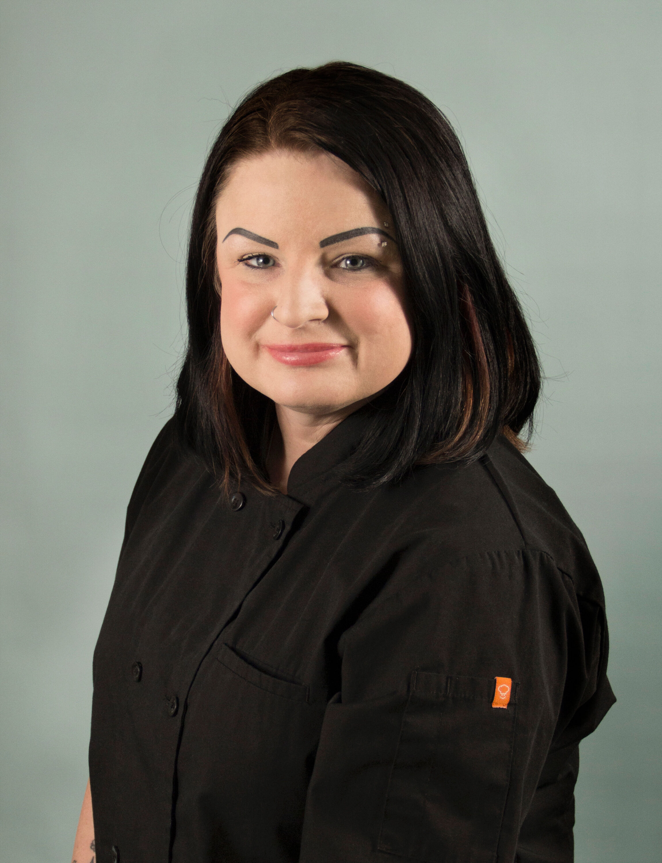 Woman in black chef coat portrait