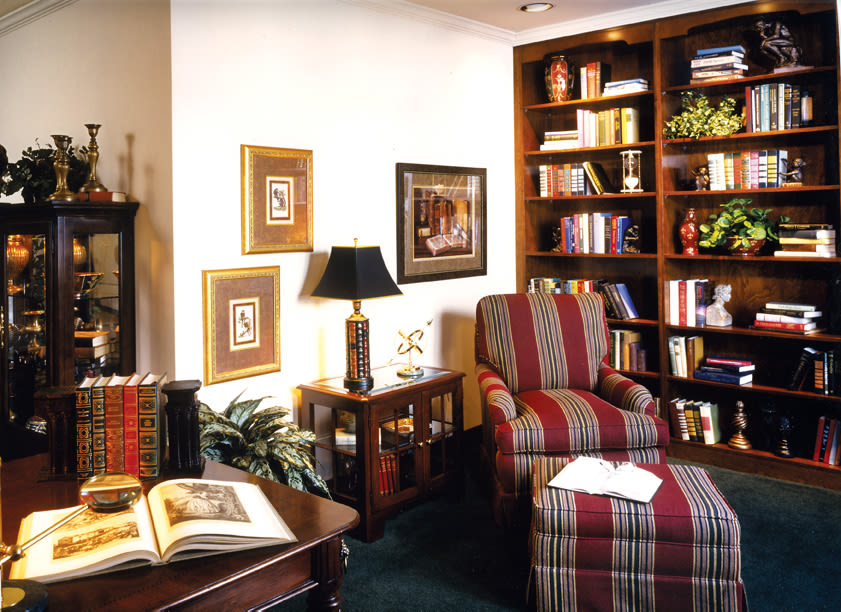 Cozy home library with armchair and bookshelves