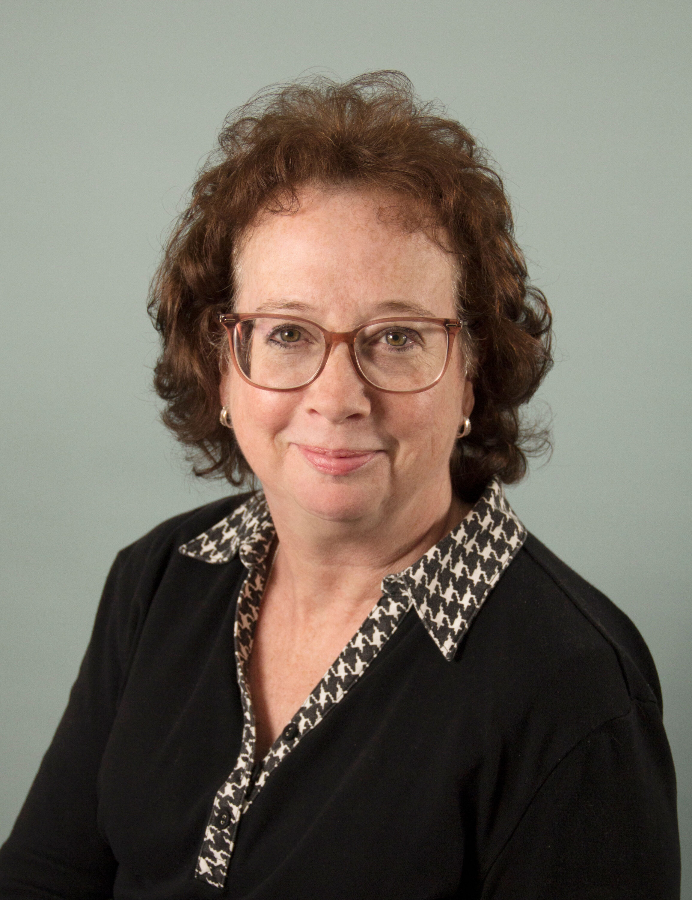 Professional headshot of woman with glasses