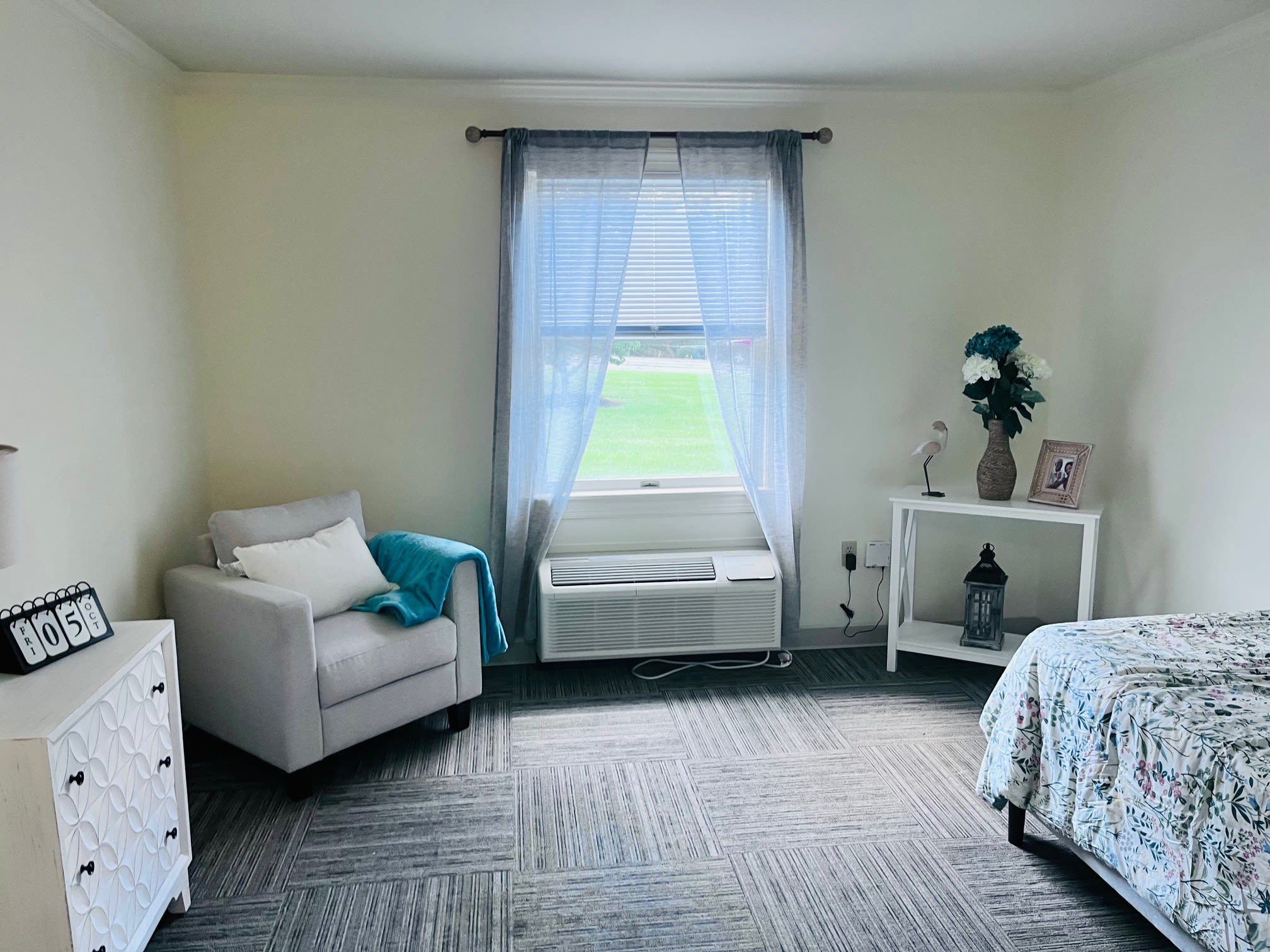 Bright bedroom with armchair and window view