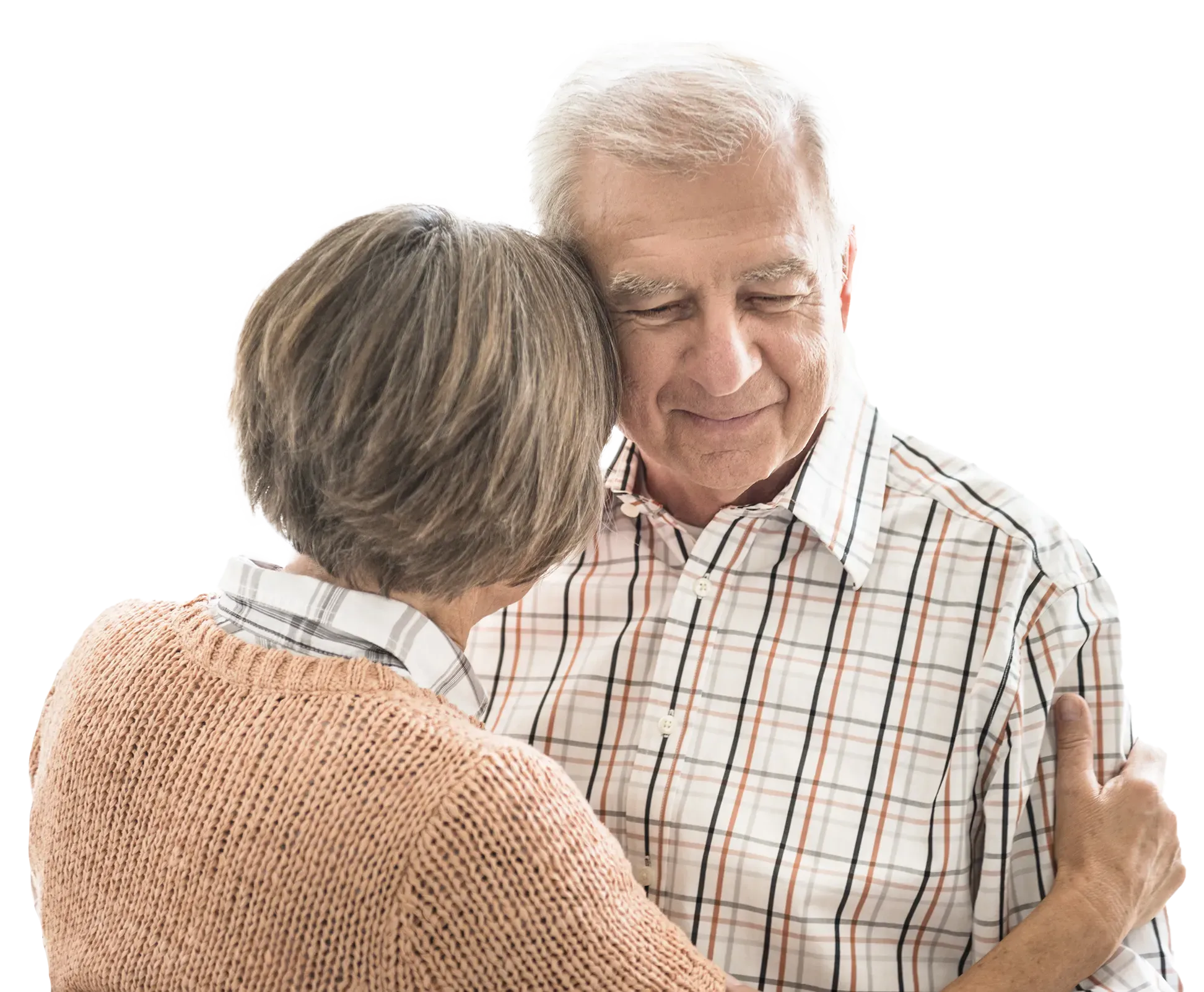 Elderly couple sharing a warm embrace indoors